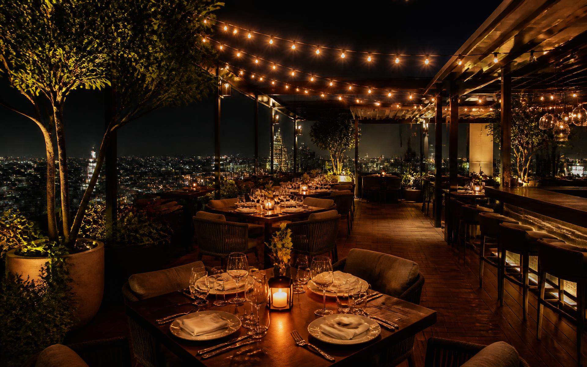 Rooftop dining terrace at Hotel Waghmare at night